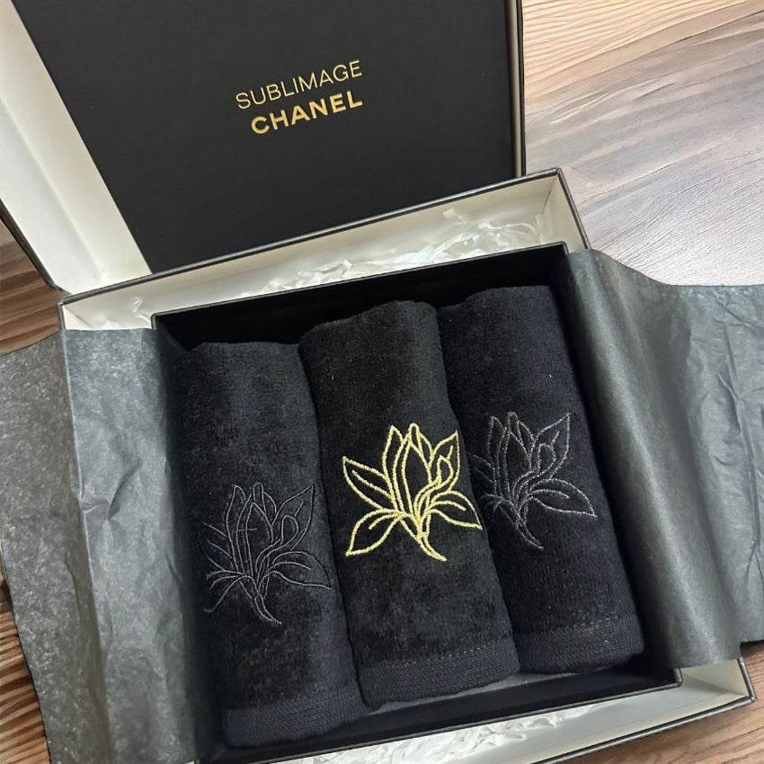 Chanel black embroidered towels in a box of three